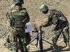 Soldiers from the Afghan National Army, 1st Brigade, 203rd Corps, begin to drop a round into their 82mm mortar system during a live-fire exercise that marked the conclusion of a two-week mortarmen course at the Fires Center of Excellence, Camp Parsa, Afghanistan, Jan. 3, 2013. (U.S. Army photo by 1st Lt. Bryan Spear, 3-320th FA, Unit Public Affairs Representative)
