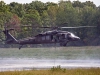 Crew members on a UH-60 Black Hawk helicopter with A Company, 6th Battalion, 101st Combat Aviation Brigade, 101st Airborne Division (Air Assault)  monitor a water bucket that is filling up with water as the helicopter pilots maintain a steady hover over Lake Kyle during wildfire operations training at Fort Campbell, Ky., August 19, 2013. (U.S. Army photo by Sgt. Duncan Brennan, 101st CAB Public Affairs)