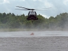 A UH-60M Black Hawk helicopter with A Company, 6th Battalion, 101st Combat Aviation Brigade, 101st Airborne Division (Air Assault)  scoops up water into a bucket slung from the helicopter during wildfire operations training at Fort Campbell, Ky., August 19, 2013. (U.S. Army photo by Sgt. Duncan Brennan, 101st CAB Public Affairs)