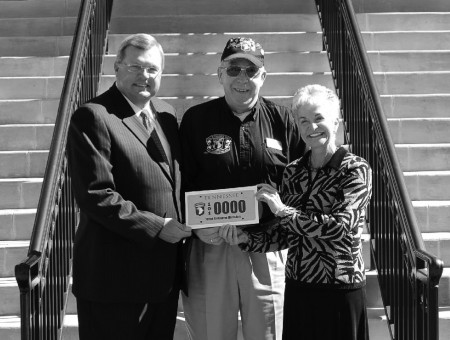 From left, Rep. Curtis Johnson, Association Secretary/Treasurer Sam Bass, and Representative Rosalind Kurita stand outside the Clarksville Courthouse with the new 101st license plate. Photo by 101st Association Graphic Designer Katie Rodriguez.