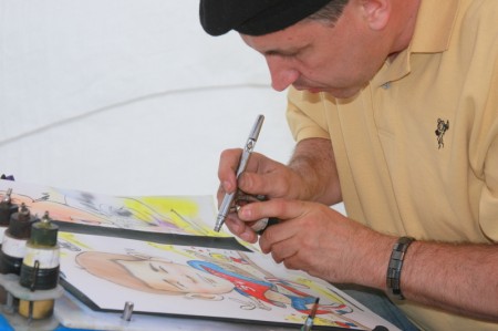 A artist paints a caricature of a local boy