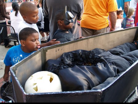 These boys make sure to grab for the candy, but not before one of them makes a face at the boogeyman.