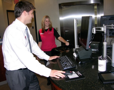 FCFU-dialogue branch Branch Manager Joshua Wooley and Assistant Manager Joy Daniels demonstrate the open desk set up of the new dialogue branch at 2193 Madison Street