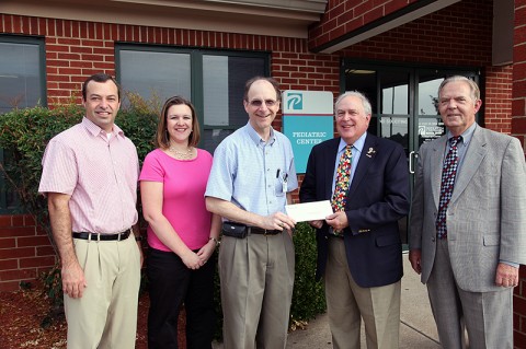 Premier Medical Group physicians Dr. Paul Darke, Dr. Stephanie Schultz and Dr. Bill Moore present the check to School Board Chair Jim Mann and Education Foundation Vice President Jimmy Dunn.