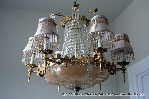 An ornate chandelier provides light for the central stairwell.