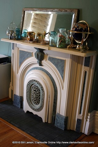 A working fireplace with an iron ornamental cover