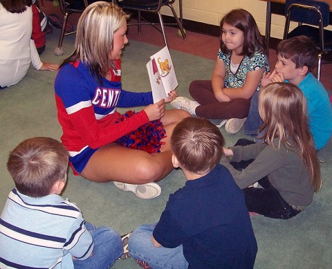 Leighana Morrison, a Montgomery Central High cheerleader, reads to elementary students as part of the “CheeReader” program.