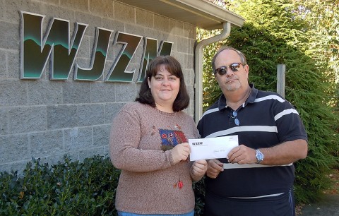 Comedy on the Cumberland organizer Hank Bonecutter presents HSCMC Programs Director Amy Shaver with $3420 in proceeds from ticket sales for the October 12th COTC benefit show.