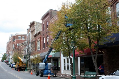City workers add Christmas Tree lights to the trees in Historic Downtown Clarksville