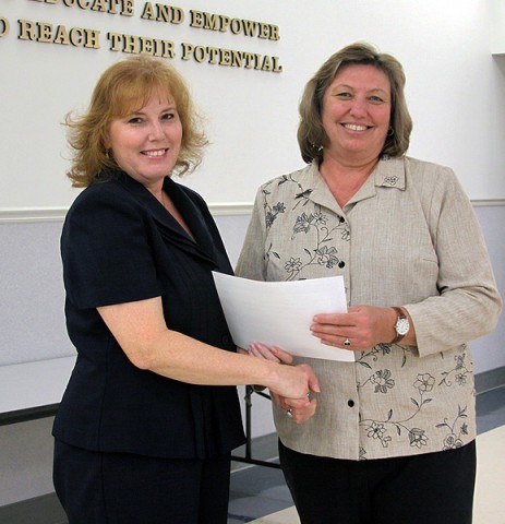 Northwest guidance counselor Karen Stasiorowski recieves the Point of Pride award from School Board member Carol Smithson.
