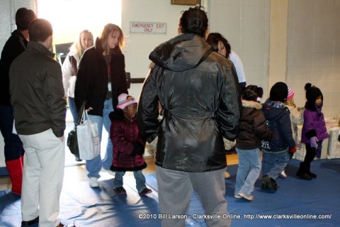 Children stream into the First Baptist Church Gym for the Kiwanis Club Children's Christmas Party