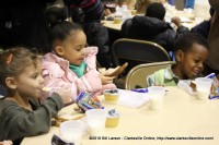 Kids eating their sack lunches at the Kiwanis Club Children's Christmas Party