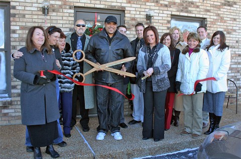 Claudia George, owner of Shear Madness, cuts the ribbon to officially open her new business, located at 2150 Wilma Rudolph Blvd. Suite 8, while members of the Clarksville Chamber of Commerce look on.