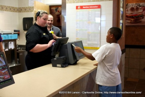 A young man ordering a Frosty is the first customer at the newly re-opened Wendy's Restaurant