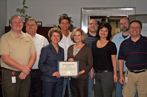 Clarksville Mayor Kim McMillan, center left, presents a certificate of appreciation to Jeannie Hiller for her 35 years of service to the City of Clarksville as the IT staff looks on.
