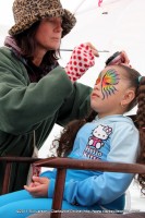 A young girl gets her face painted