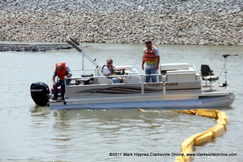 TMS Contracting moving the turbidity barrier from the mouth of the Marina Basin using a Crestliner pontoon boat on loan from Bill Roberts Thunder Road Marina.