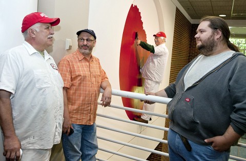 APSU painter Ivan Colon, art professor Gregg Schlanger and art student Tobey Lee stand near the new public art display in the APSU Morgan University Center. (Photo by Beth Liggett/APSU Public Relations and Marketing)