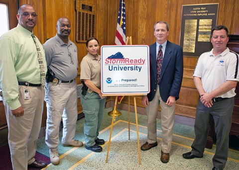 Austin Peay State University Chief of Police Lantz Biles (from left), Lt. Carl Little and Sgt. Georganna Genthner on May 24 receive a sign designating APSU as a StormReady University from Larry Vannozzi, meteorologist in charge with the National Weather Service in Nashville, and Tom Johnstone, also with the NWS Nashville bureau. (Photo by Beth Liggett, APSU Public Relations and Marketing)