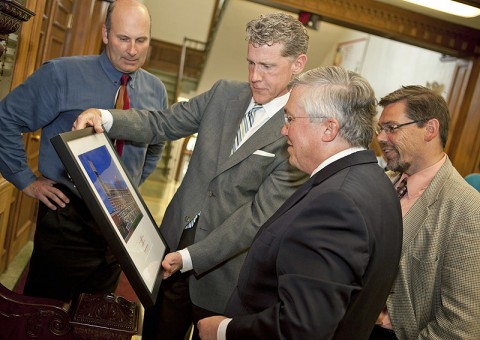 Garry Askew and Tom Bauer, with Bauer Askew Architecture, present APSU President Tim Hall and APSU Provost and Vice President of Academic Affairs Tristan Denley with a framed print of the University’s Hemlock Semiconductor Building. (Photo by Beth Liggett/APSU Public Relations)