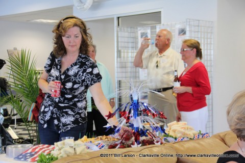 A business after hours guest samples some of Mrs. Roberts fruit and cheeses at Thunder Road Marine