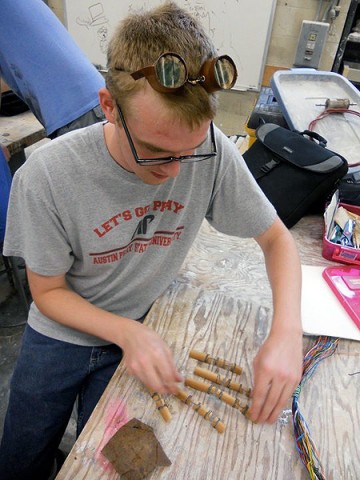 APSU student Jeffrey Horton works on a sculpture of a hand while taking a Steampunk Sculpture class at APSU this summer. The goggles he is wearing were also part of a project for the class. (Photo By Mike Mitchell)