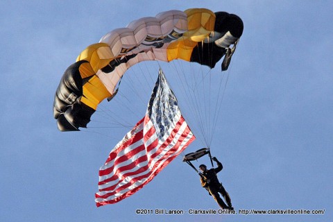 A member of the 101st Airborne Division Parachute Demonstration Team comes in streaming the U. S. Flag