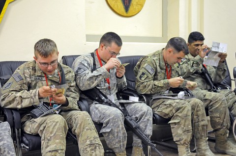 Soldiers with the 101st Finance Management Company, 101st Special Troops Battalion, 101st Sustainment Brigade, use magnifying glasses and ultraviolet lights to identify fake money during a counterfeit currency training. (Photo by Spc. Michael Vanpool) Soldiers with the 101st Finance Management Company, 101st Special Troops Battalion, 101st Sustainment Brigade, use magnifying glasses and ultraviolet lights to identify fake money during a counterfeit currency training. (Photo by Spc. Michael Vanpool)