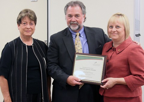 David Smith, past president of the local Chamber of Commerce, present the Partner Service Award to Dr. Becky McMahan, a faculty member in the APSU College of Education, and Carol Clark, director of community and business relations and executive assistant to the president, during the annual Partners in Education Appreciation Breakfast on September 14th. (Photo provided by the CMCSS)