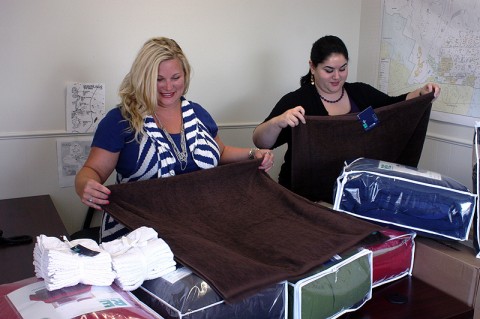 Campbell Crossing employees prepares some linens that will be donated to the Montgomery County Safe House as part of Lend Lease Community Day.