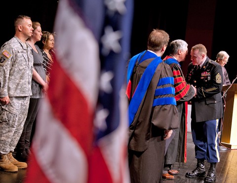 Command Sgt. Maj. Wayne P. St. Louis (right) receives APSU Military Coin from APSU President Tim Hall (left) during a ceremony held Wednesday. (Photo by Beth Liggett, APSU photographer)