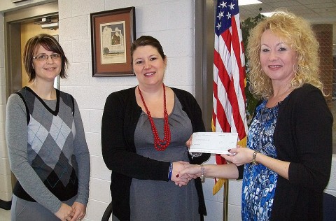 Planters Bank Branch Manager and Assistant Vice President Stacey Wenzler presents a check to Rossview High School Assistant Principal Schanda Dowdy and Librarian Valerie Meadows.