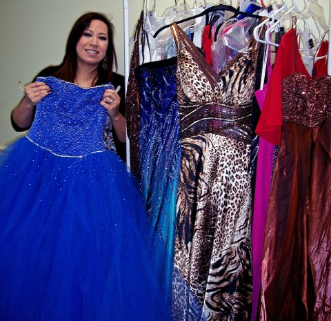 Maria Scott, High School Presenter for Miller-Motte, shows off some of the available dresses at Prom-O-Rama on Saturday. (Photo by: Lois Jones)