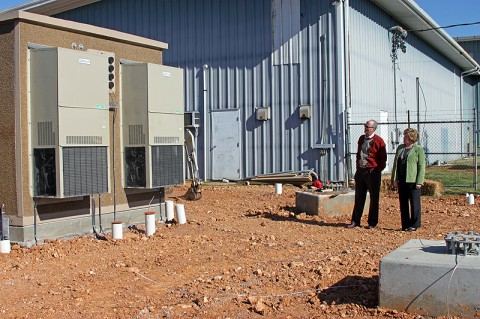 Phil Harpel and Montgomery County Mayor Carolyn Bowers survey one of the buildings that will house the tower equipment. The tower foundation and equipment buildings have already been completed on-site.