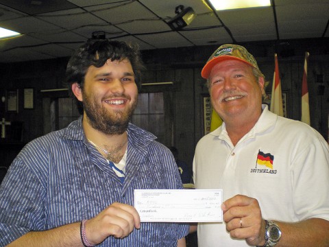 Eric Ezzell (left), who is studying German at Austin Peay State University, receives a scholarship from Jim Nolan, president of the Clarksville Edelweiss Club. 