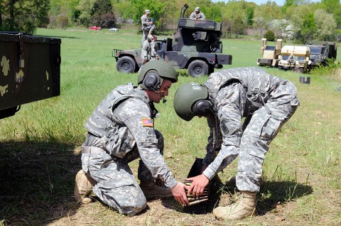Pfc. Shawn Bandy, a gunner with B Battery, 2nd Battalion, 44th Air Defense Artillery Regiment, 101st Sustainment Brigade, and Spc. Arturo Gonzalez, a team chief with B Battery, load .50-caliber ammunition during a crew drill, April 3rd. The two air defenders are competing to be the 2-44 ADA’s Best Stinger. The competition measures the two-man teams based on physical fitness, crew drills and air defense knowledge. (Photo by Spc. Michael Vanpool) Pfc. Shawn Bandy, a gunner with B Battery, 2nd Battalion, 44th Air Defense Artillery Regiment, 101st Sustainment Brigade, and Spc. Arturo Gonzalez, a team chief with B Battery, load .50-caliber ammunition during a crew drill, April 3rd. The two air defenders are competing to be the 2-44 ADA’s Best Stinger. The competition measures the two-man teams based on physical fitness, crew drills and air defense knowledge. (Photo by Spc. Michael Vanpool)
