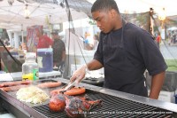 A young man grills up some of the delicious festival foods