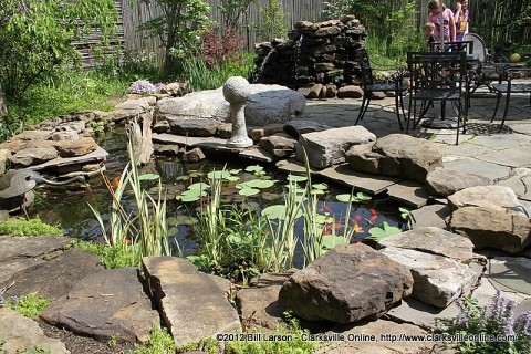 A Large goldfish pond is the center piece of the outdoor dining area