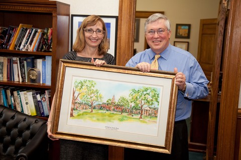 APSU associate professor of history Dr. Minoa Uffelman presents APSU President Tim Hall with a watercolor painting by local artist Lynne Waters Griffey, in recognition of the 40th anniversary of the Sigma Kappa chapter of the Chi Omega Women’s Fraternity at APSU. (Photo by Beth Liggett/APSU staff).