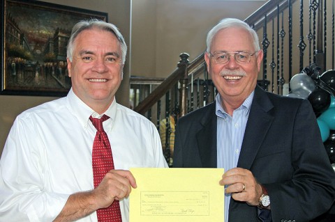 Hemlock Semiconductor Group Site Manager Terry Strange (right) presents a $20,000 Dow Corning Foundation grant to CMCSS Director Dr. B.J. Worthington. The grant will fund teacher externships.