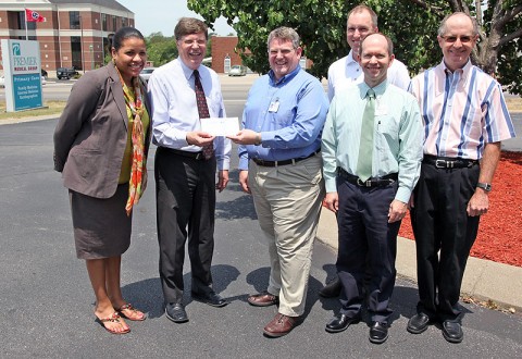 CMCSS Director of Schools Mike Harris, and Foundation Director Candy Johnson accept an $11,000 sponsorship gift from Premier physicians (from left) Dr. Michael Engel, Dr. Joe Kosinski, Dr. Lance Sherley, and Dr. Mike Carrigan. 