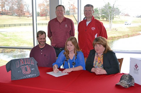 KayCee and her parents, Coach Greg Lyle in the red jacket and Jeff Vaughn.
