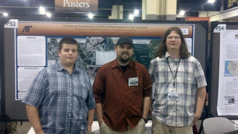 APSU students James Martin, Maurice Testa and Eric Whitaker stand before their poster at the Geological Society of America meeting. 