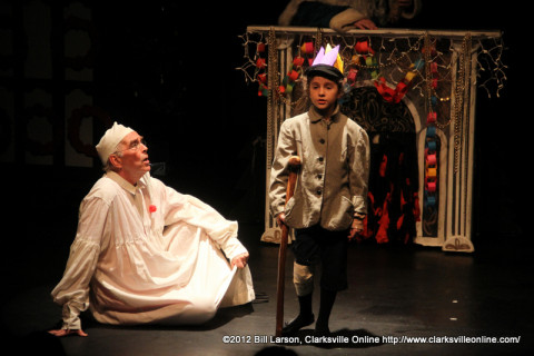 Scrooge learns a Christmas lesson from Tiny Tim in A Christmas Carol at the Roxy Regional Theatre