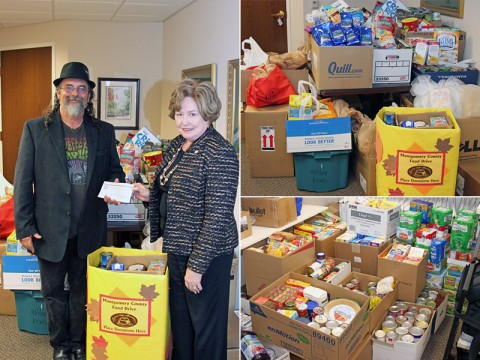 Kenny York accepts a $500.00 check from Montgomery County Mayor Carolyn Bowers as part of the County food drive for Manna Café. Besides the cash donation, the county raised over 2,600 pounds of food.