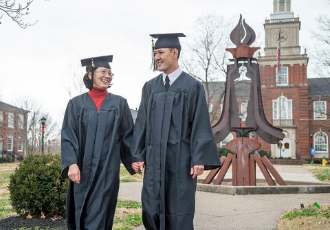 Staff Sgt. Chris Minor and his wife Elvira walk on the lawn in front of the Browning Administration Building at the APSU main campus. The couple will graduate December 14th with their bachelor’s degrees from APSU. (Photo by Beth Liggett, APSU photographer)