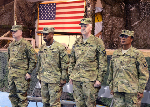 (Left-to-right) U.S. Army Col. James Davis and Command Sgt. Maj. Maurice Chaplin, Division Headquarters and Headquarters Battalion, 1st Infantry Division command team, along with Lt. Col. Scott Noon and Command Sgt. Maj. Tonika Scott-Morris, Division Headquarters and Headquarters Battalion, 101st Airborne Division (Air Assault) participate in a battalion casing and uncasing ceremony, respectively, Feb. 28, 2013, at Bagram Airfield. (U.S. Army photo by Sgt. 1st Class Kevin Hartman, 115th Mobile Public Affairs Detachment)