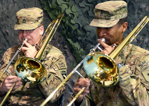 U.S. Army Staff Sgt. Vincent Lawyer (left), a trombone player with the 101st Airborne Division (Air Assault) Band, and Sgt. 1st Class David McDonald, also a trombone player with the 1st Infantry Division Band, perform during the casing ceremony for the division headquarters battalion of the 1st Infantry Division and the uncasing ceremony for the division headquarters battalion for the incoming 101st Airborne Division (Air Assault), Feb. 28, 2013, at Bagram Airfield, Afghanistan. (U.S. Army photo by Sgt. 1st Class Kevin Hartman, 115th Mobile Public Affairs)