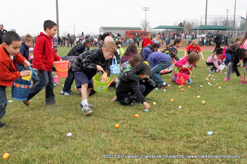 Kids scoop up Easter Eggs during the City of Clarksville's 2013 Spring Eggstravanganza Easter Egg Hunt