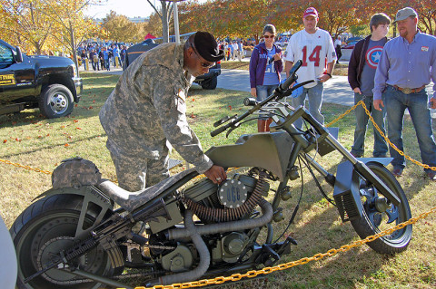 Crowds watch while one of its crew makes adjustments to the Orange County Chopper during its last appearance in middle Tennessee at LP Field in November 2011. It returns to Middle Tennessee April 19th and 20th during Rivers and Spires in downtown Clarksville. (U.S. Army photo)